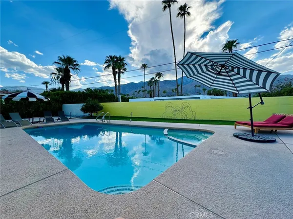 a view of a swimming pool with a yard