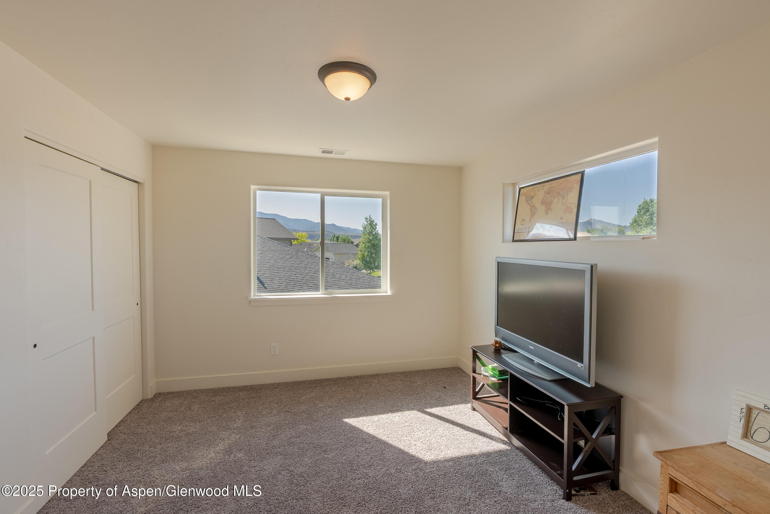 1149 East 17th Street Rifle, CO 81650 - Photo 12 of 16 a room with furniture and a flat screen tv