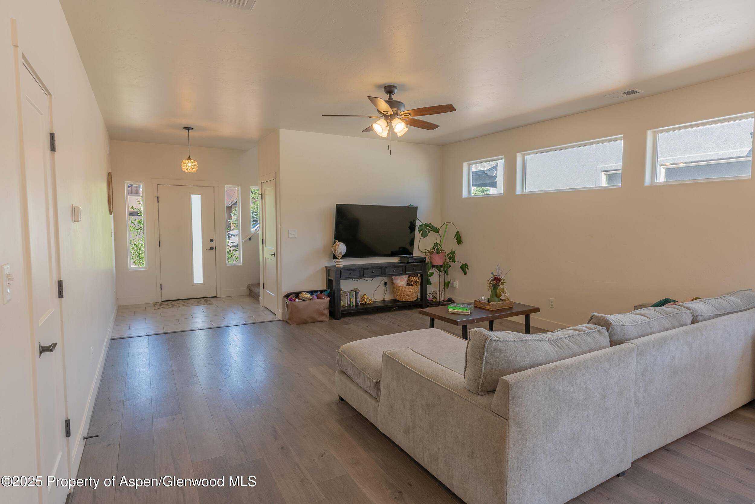 1149 East 17th Street Rifle, CO 81650 - Photo 3 of 16 a living room with furniture and a flat screen tv