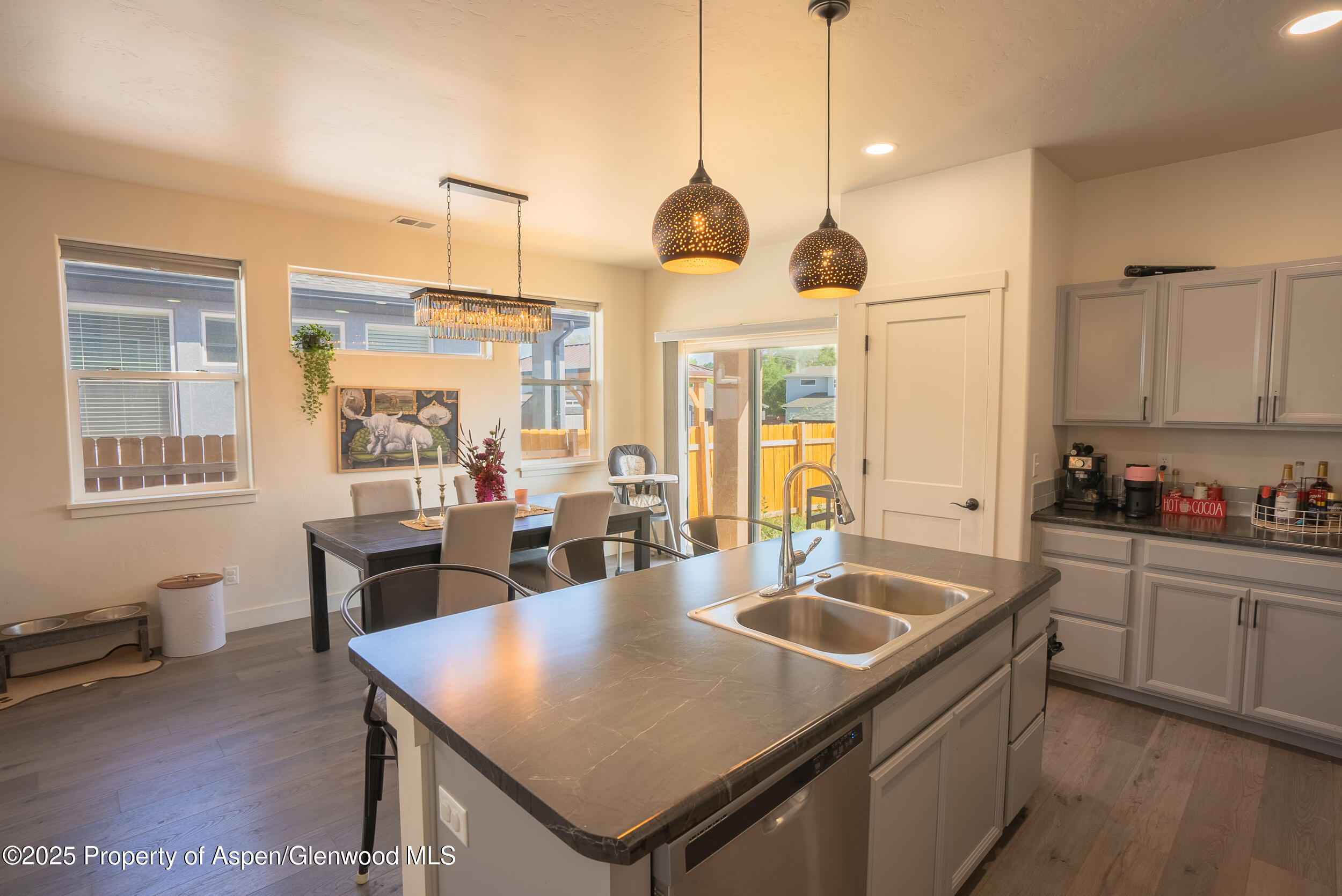 1149 East 17th Street Rifle, CO 81650 - Photo 5 of 16 a kitchen with stainless steel appliances granite countertop a sink a stove and a refrigerator