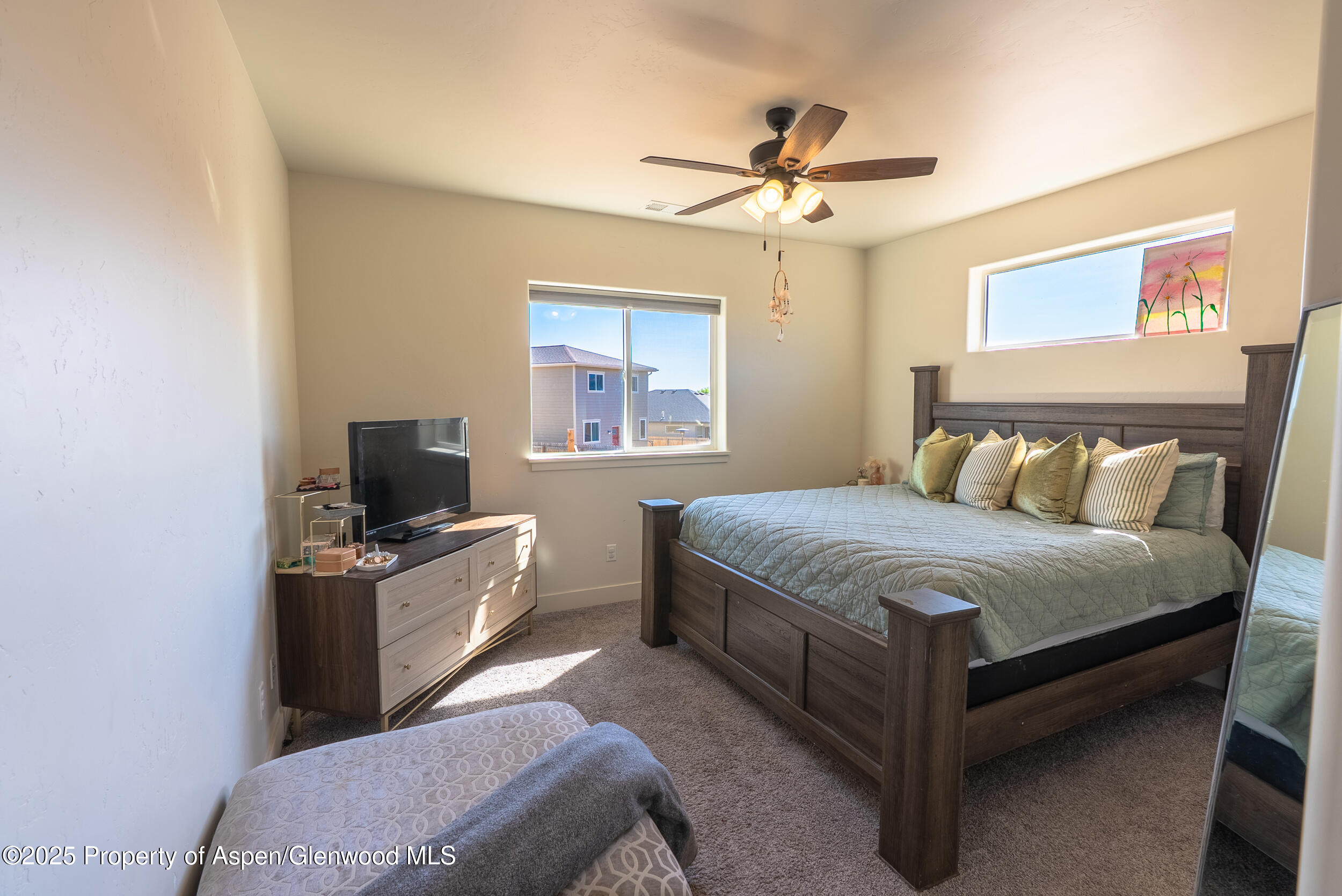 1149 East 17th Street Rifle, CO 81650 - Photo 7 of 16 a bedroom with a bed and a flat screen tv