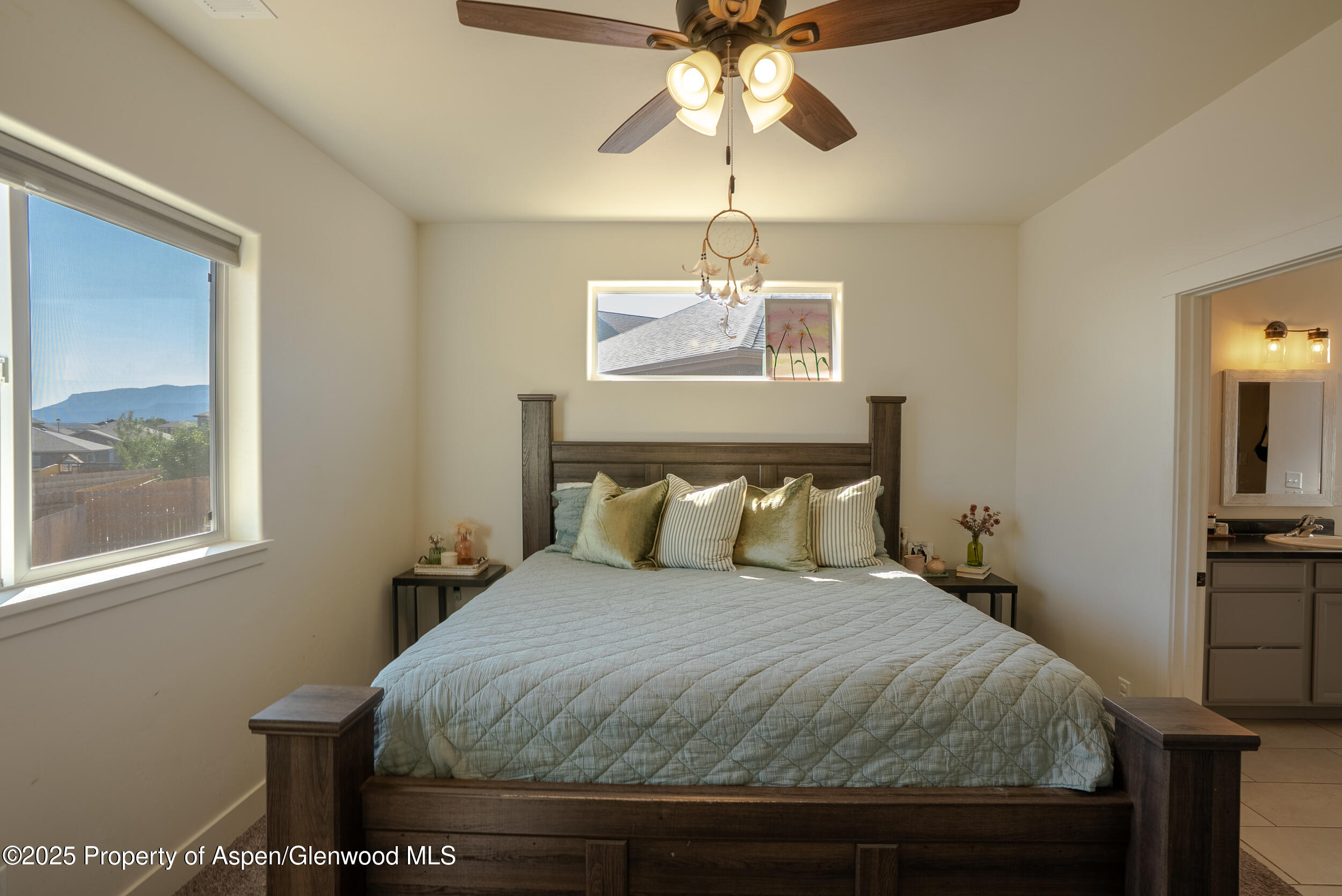 1149 East 17th Street Rifle, CO 81650 - Photo 8 of 16 a bedroom with a bed and a chandelier