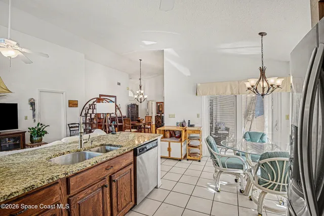 a view of a dining room with furniture wooden floor and chandelier