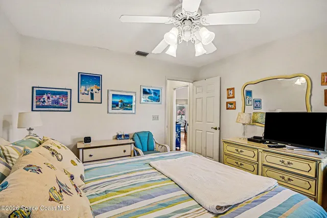 a bathroom with a toilet sink a mirror and shower