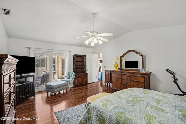a living room with patio furniture and a chandelier