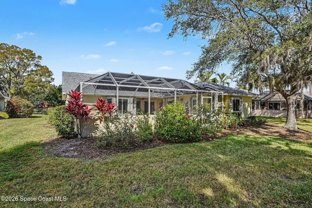 a living room with furniture a chandelier and a flat screen tv