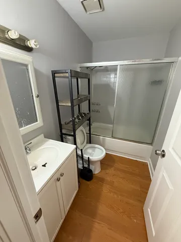 a bathroom with a sink a toilet and a shower
