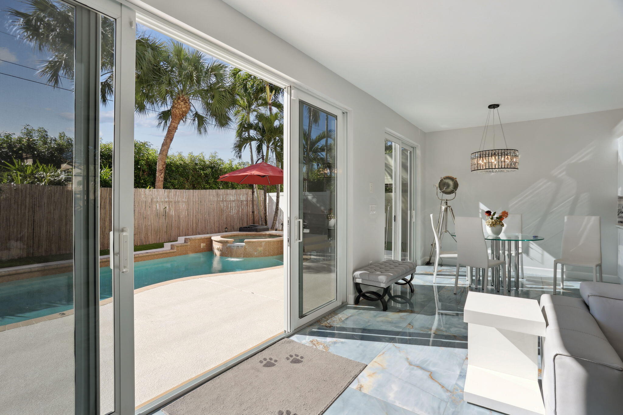 4816 South Classical Boulevard Delray Beach, FL 33445 - Photo 11 of 44 a living room with a large window and a glass door
