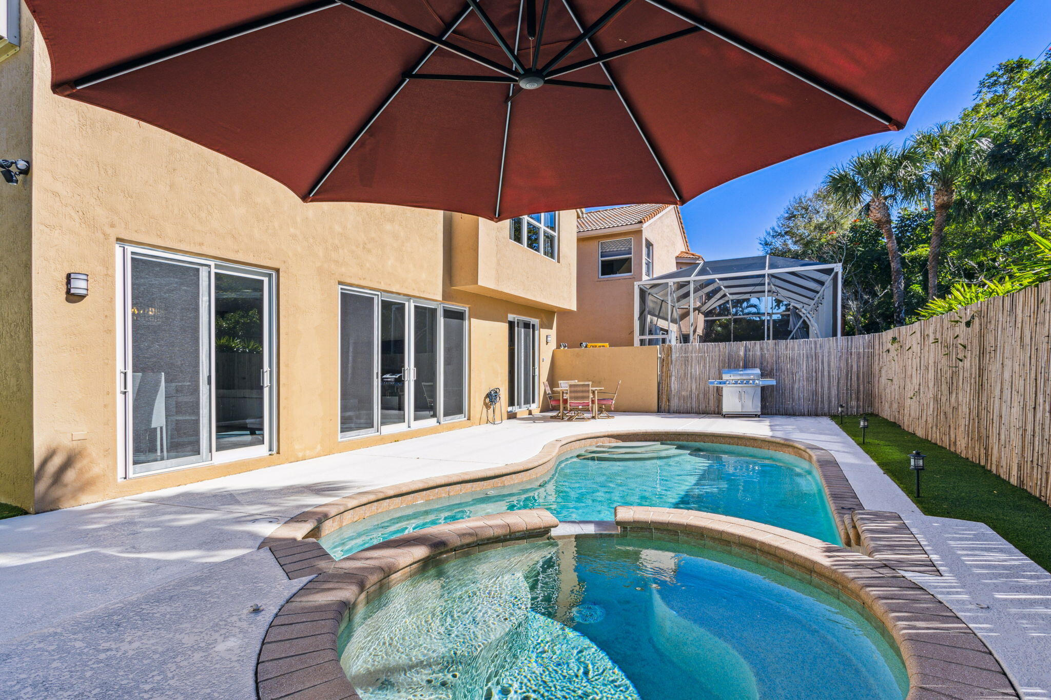 4816 South Classical Boulevard Delray Beach, FL 33445 - Photo 12 of 44 a swimming pool with patio outdoor seating and yard