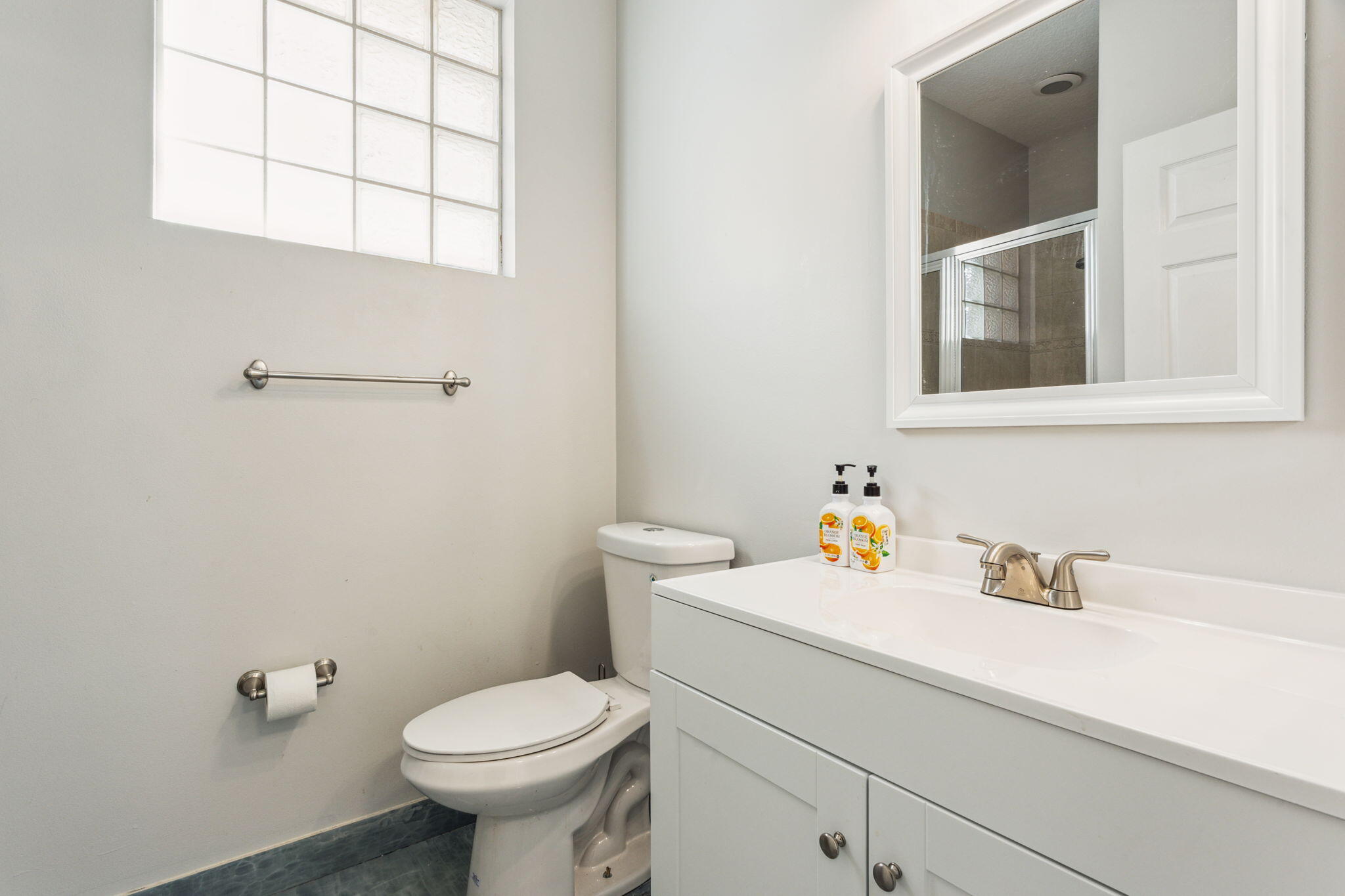 4816 South Classical Boulevard Delray Beach, FL 33445 - Photo 22 of 44 a bathroom with a sink toilet and a window