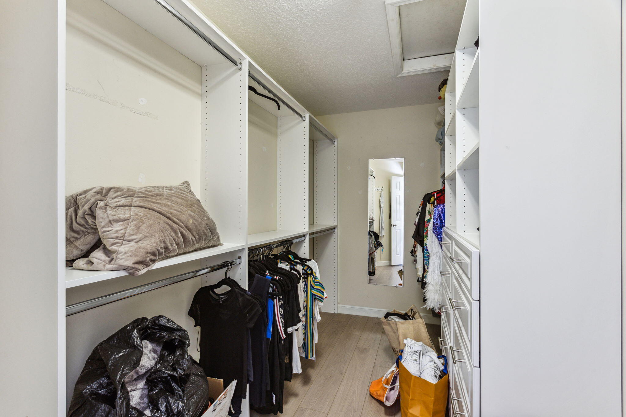 4816 South Classical Boulevard Delray Beach, FL 33445 - Photo 27 of 44 a view of walk in closet with clothes and shoes