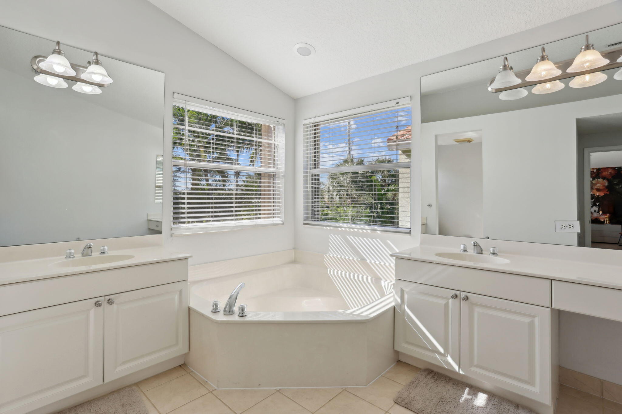 4816 South Classical Boulevard Delray Beach, FL 33445 - Photo 29 of 44 a bathroom with a granite countertop sink a large mirror and a bathtub