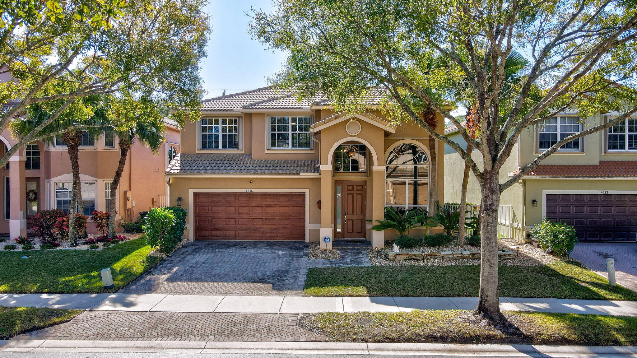 4816 South Classical Boulevard Delray Beach, FL 33445 - Photo 3 of 44 a front view of a house with garden