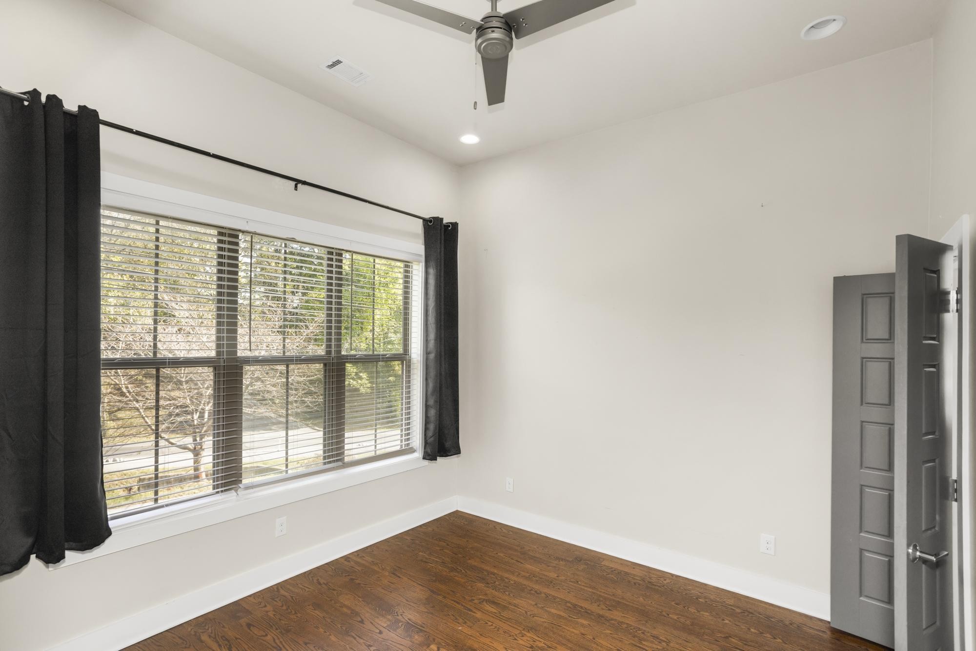 942 Riverside Drive Nashville, TN 37206 - Photo 11 of 33 a view of an empty room with a window and wooden floor