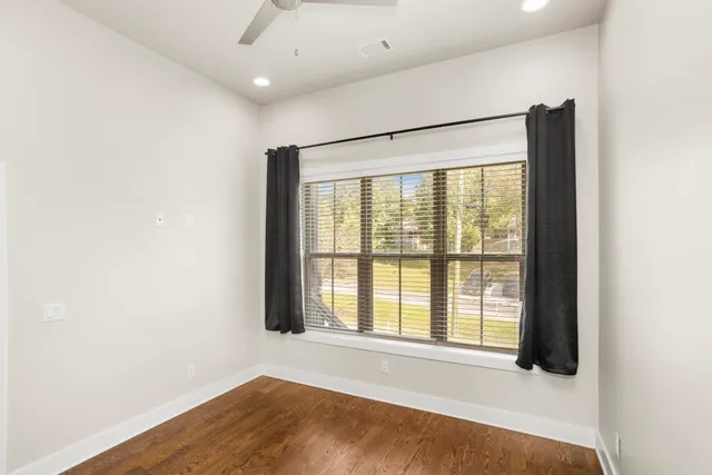 a big room with wooden floor and windows