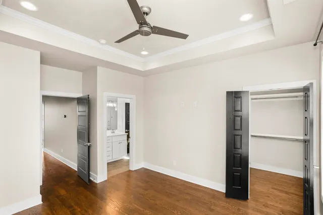 a view of an empty room with wooden floor