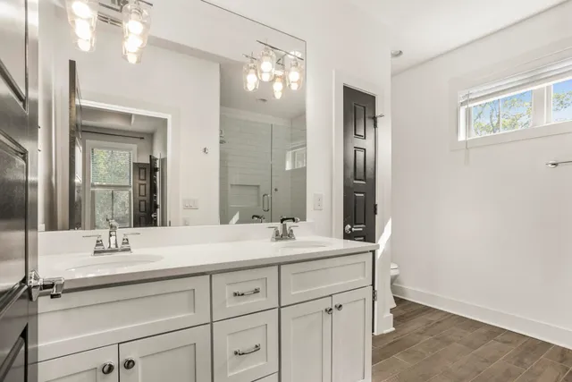 a bathroom with a double vanity sink mirror and double