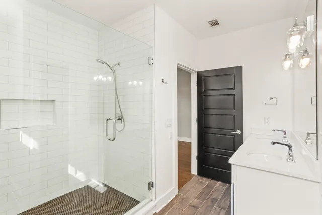 a bathroom with a shower and a sink