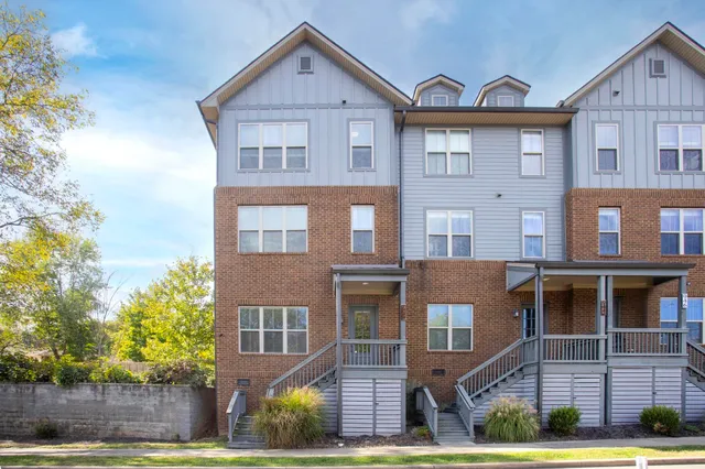 a front view of residential houses with yard