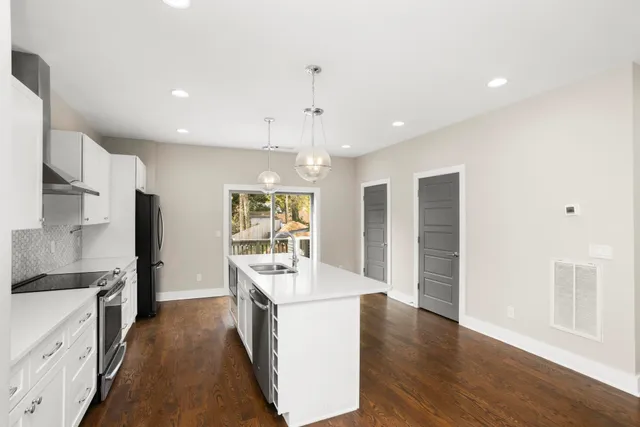 a large kitchen with a large counter top appliances and cabinets