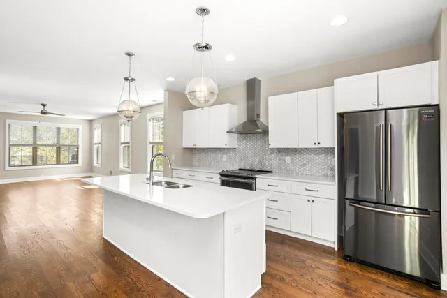 a kitchen with stainless steel appliances a refrigerator sink and stove