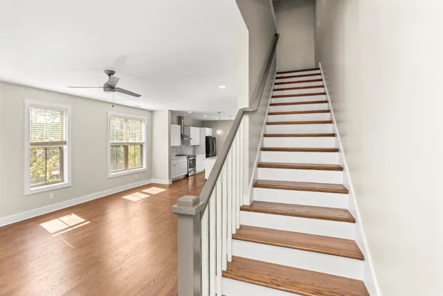 a view of an entryway with wooden floor and stairs