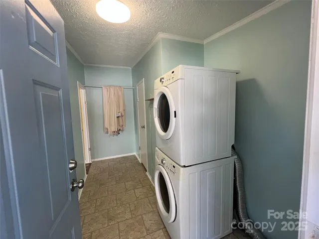 en empty room with windows and chandelier fan