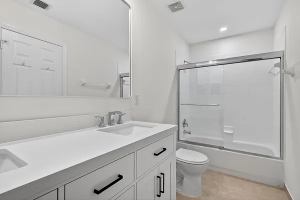 a bathroom with a shower and a bath tub
