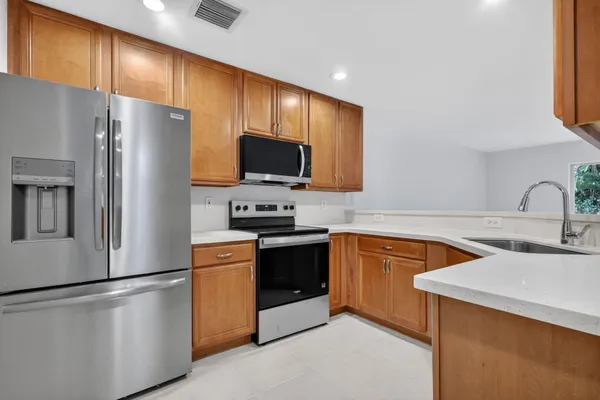 a kitchen with granite countertop a sink and cabinets