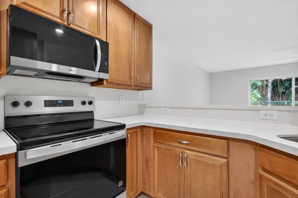 a kitchen with a sink stove and microwave