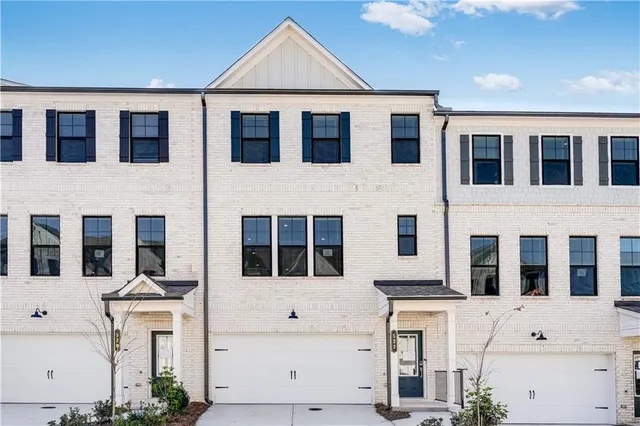 a view of a white building with many windows