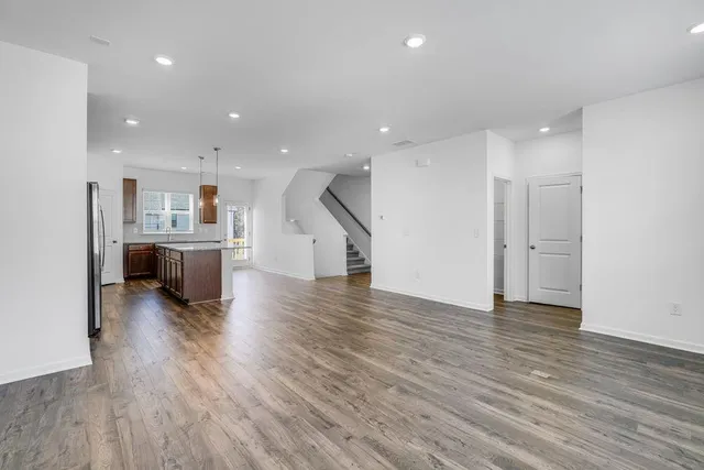 a view of a kitchen with wooden floor and a sink