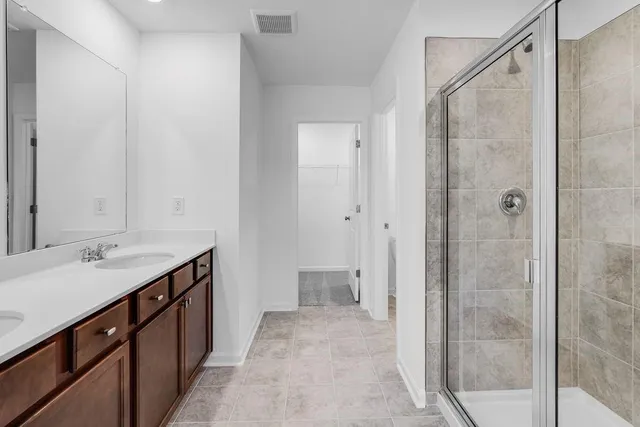 a spacious bathroom with a shower and a sink
