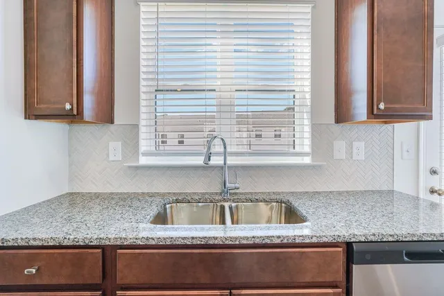 a kitchen with granite countertop a sink and a window