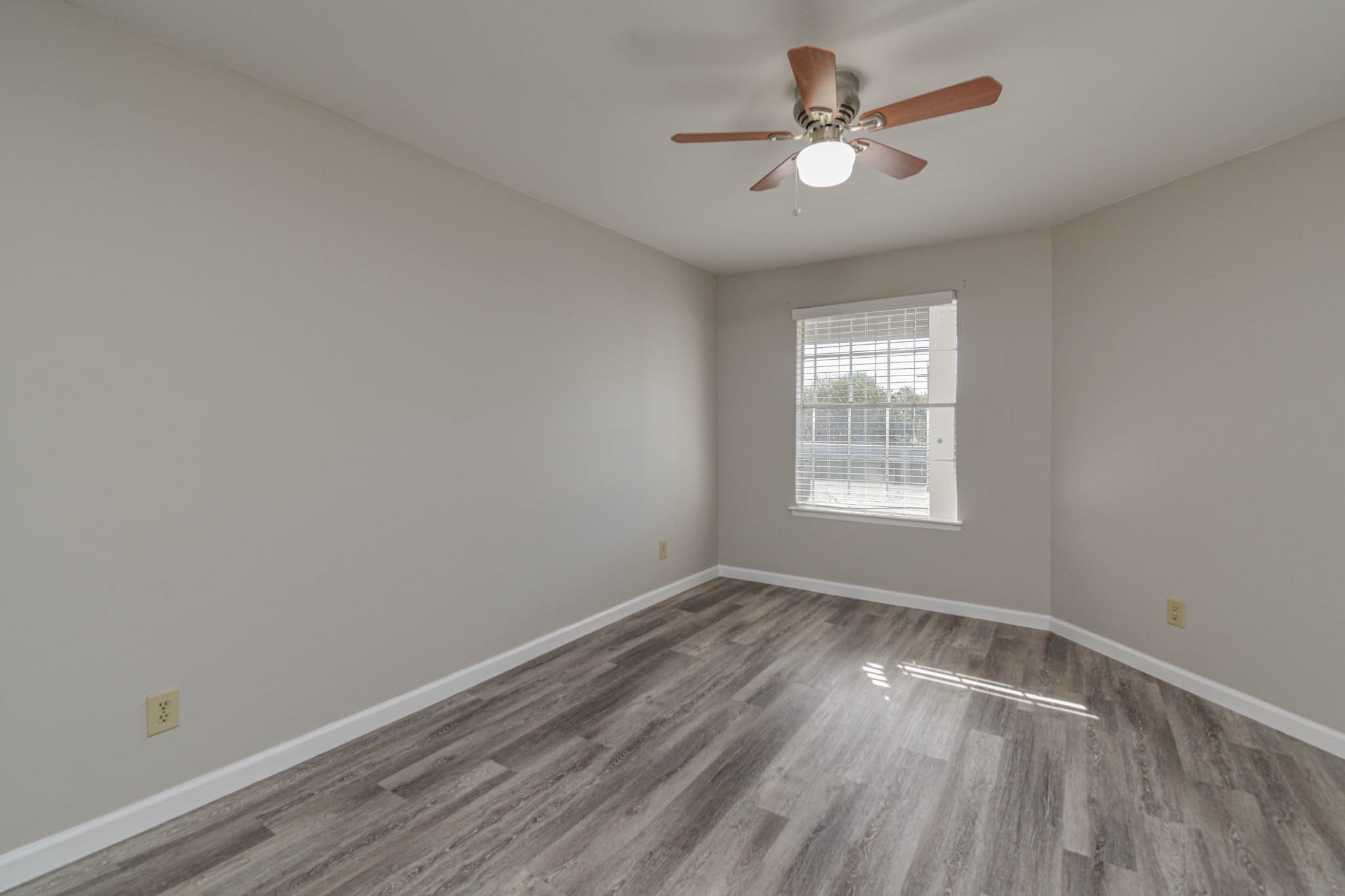 8787 Brae Acres Road, Unit 814 Houston, TX 77074 - Photo 21 of 23 wooden floor in an empty room with a window