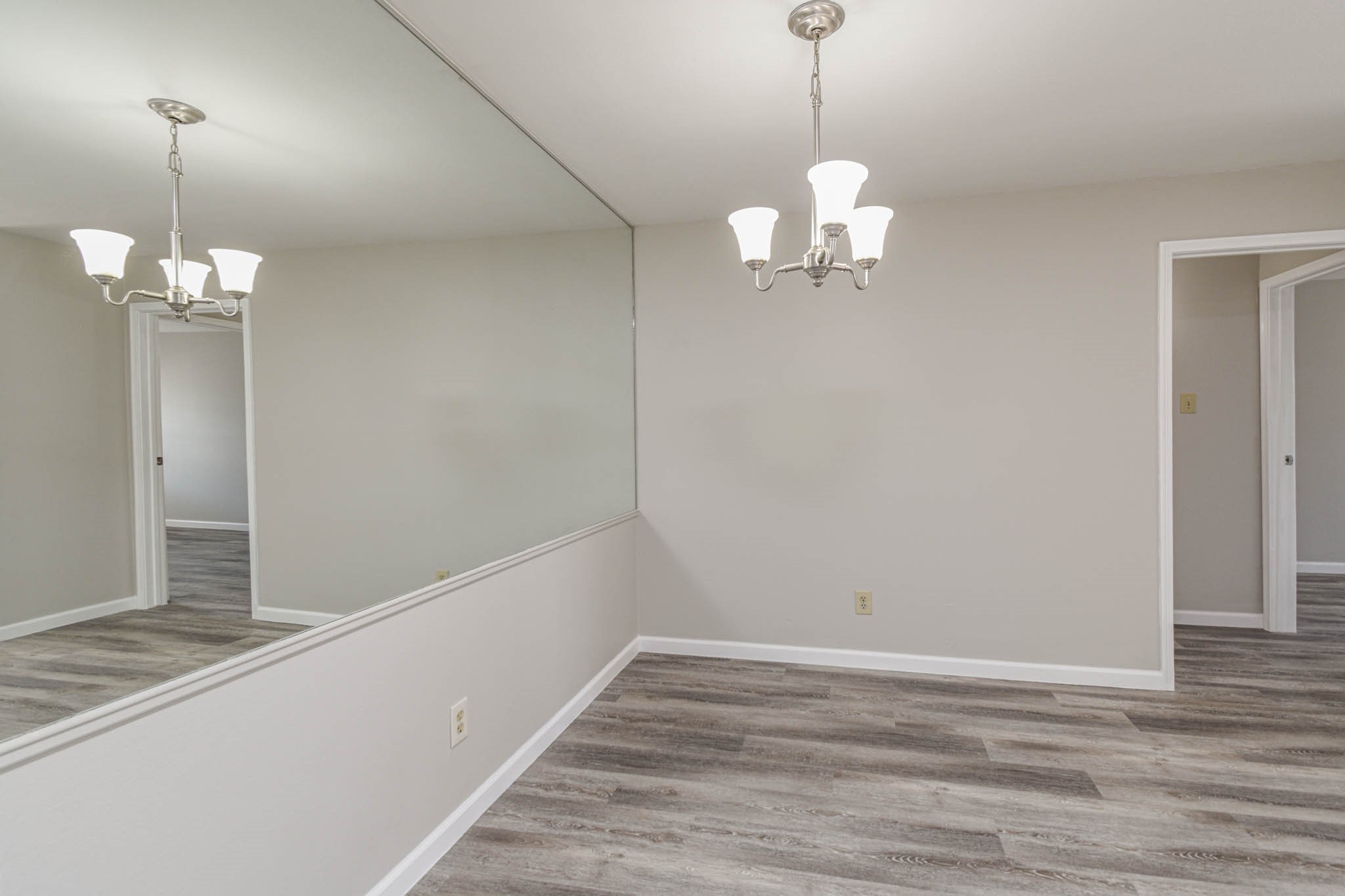 8787 Brae Acres Road, Unit 814 Houston, TX 77074 - Photo 6 of 23 a view of a room with wooden floor and chandelier