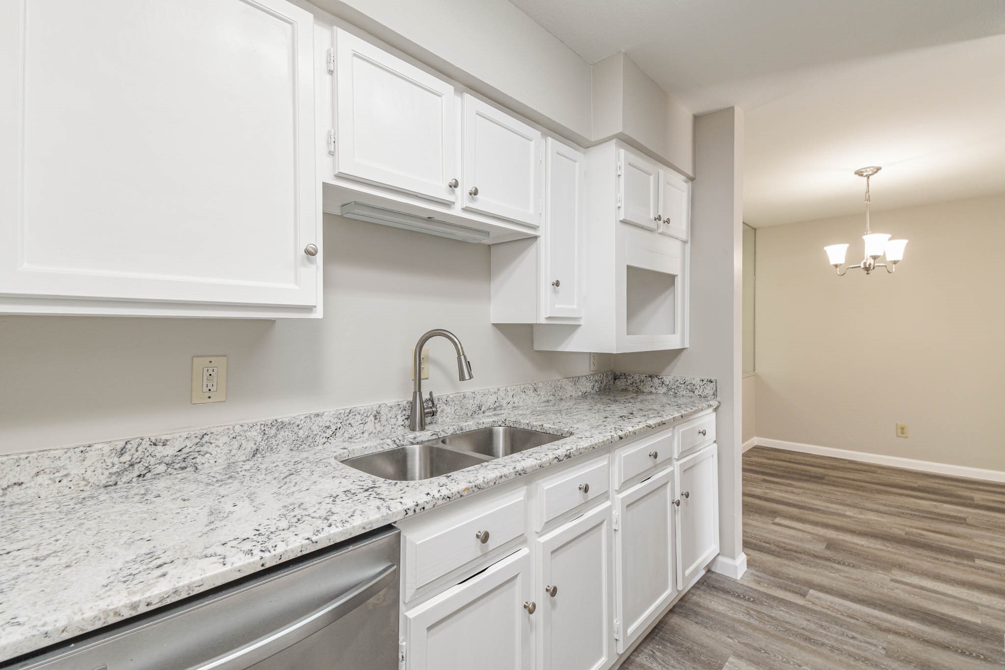 8787 Brae Acres Road, Unit 814 Houston, TX 77074 - Photo 7 of 23 a kitchen with granite countertop white cabinets and a sink