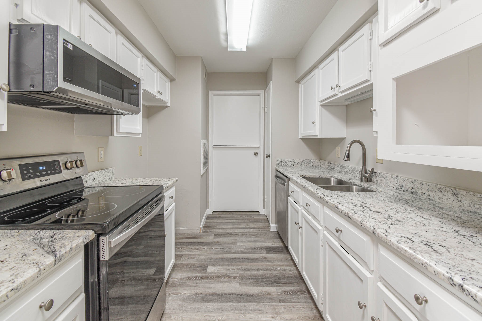8787 Brae Acres Road, Unit 814 Houston, TX 77074 - Photo 8 of 23 a kitchen with stainless steel appliances granite countertop a sink and dishwasher stove a oven with wooden cabinets