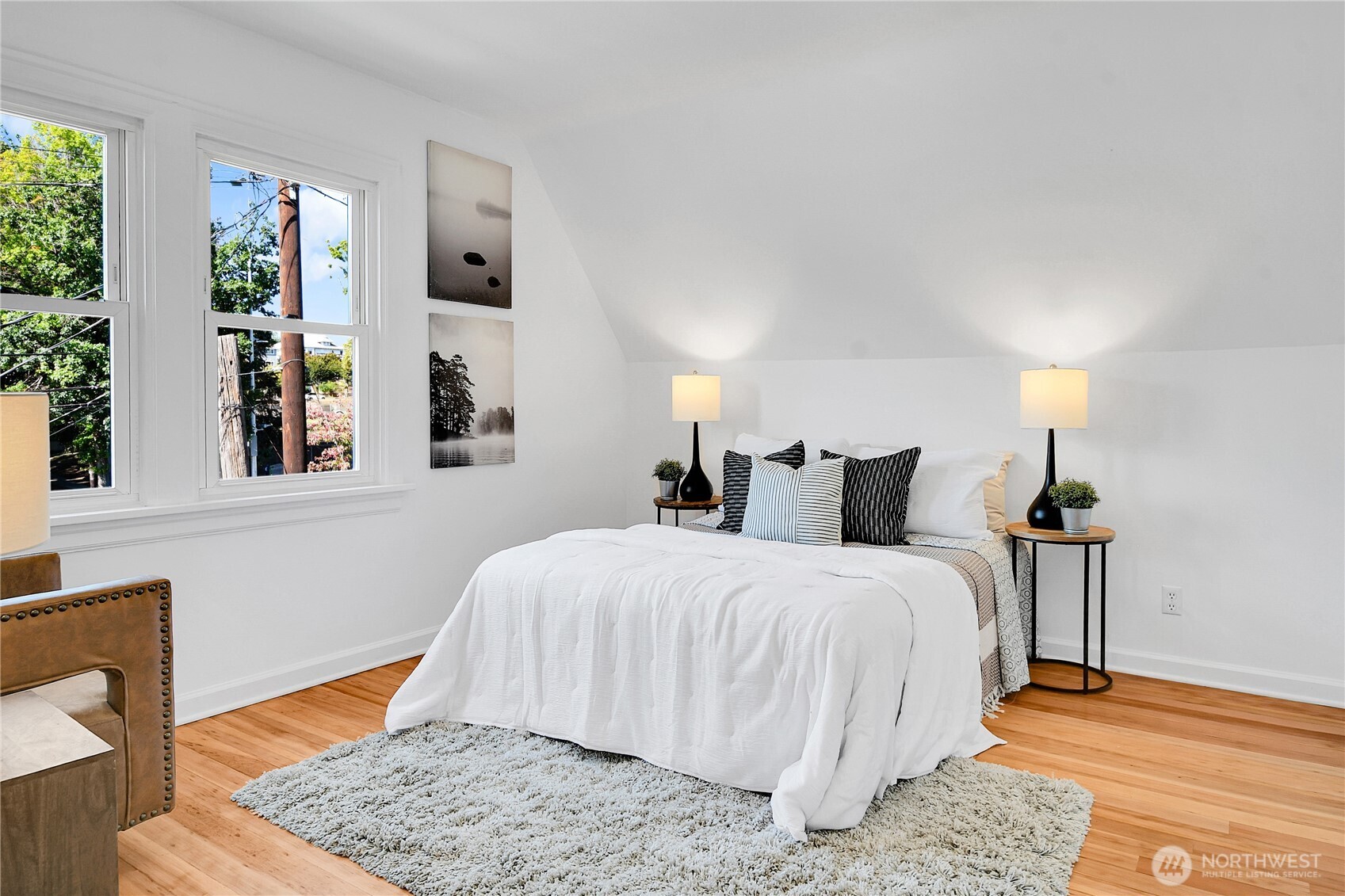 107 West Blaine Street Seattle, WA 98119 - Photo 12 of 22 a bedroom with a bed and wooden floor