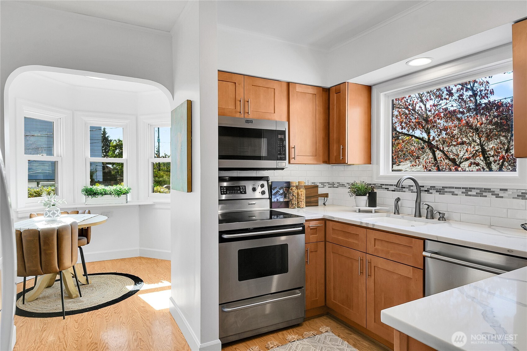 107 West Blaine Street Seattle, WA 98119 - Photo 7 of 22 a kitchen with a stove a sink and a microwave