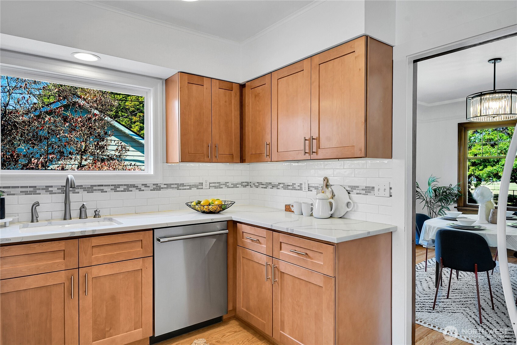 107 West Blaine Street Seattle, WA 98119 - Photo 9 of 22 a kitchen with stainless steel appliances granite countertop a sink stove and cabinets
