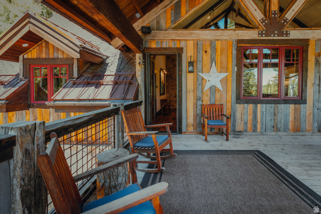 1667 West Tollgate Cyn Road Coalville, UT 84017 - Photo 50 of 61 Expansive outdoor deck featuring wood-plank flooring, a wood and wire railing, and exposed ceiling beams