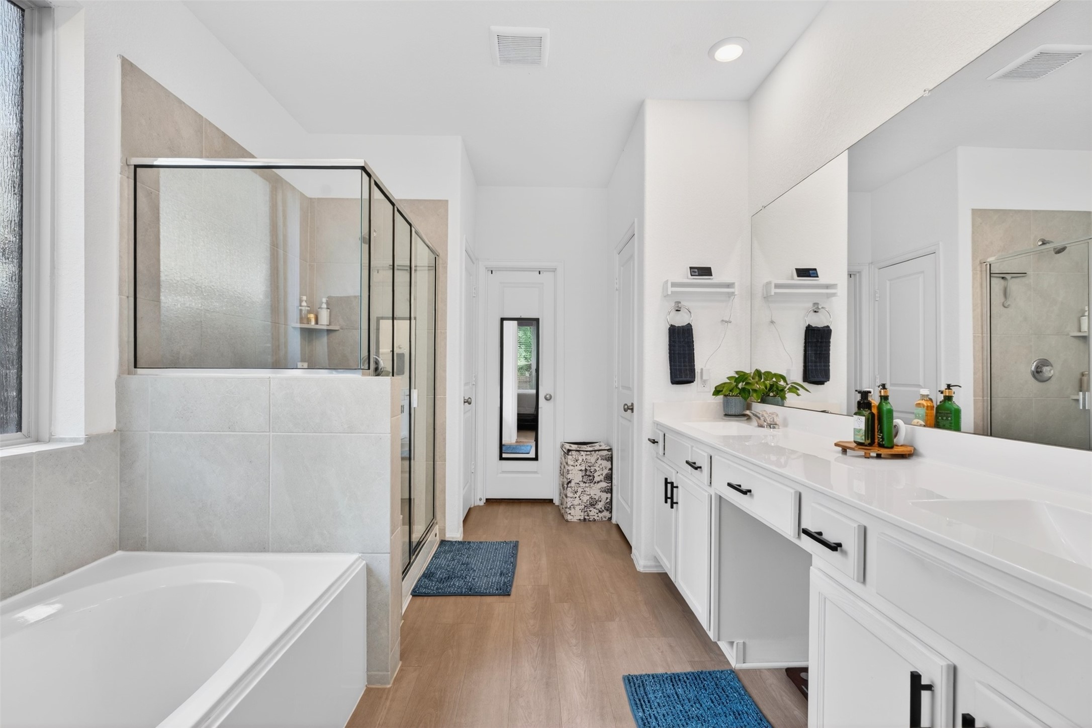 2832 Mistygate Court Conroe, TX 77301 - Photo 17 of 50 Beautiful primary bathroom featuring dual vanities, a relaxing soaking tub, and a separate shower, creating the perfect space to unwind.