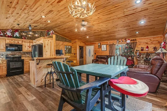 a dining room with furniture and wooden floor