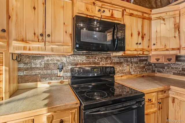 a kitchen with a stove and a microwave