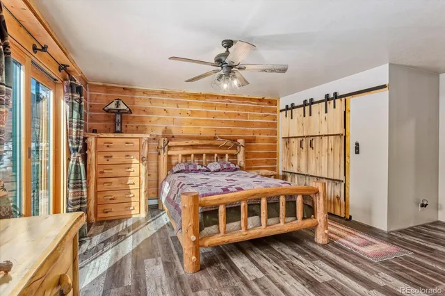 a bedroom with a bed next to a large window