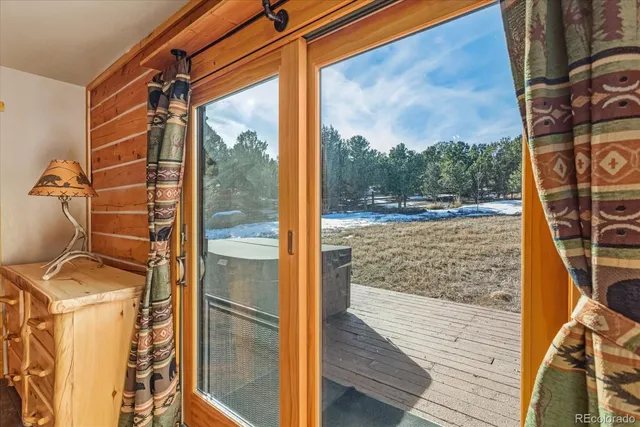 a view of a balcony with wooden floor and outdoor space