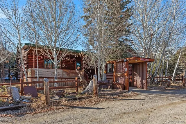 a view of a house with a yard covered in snow