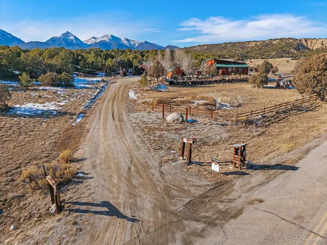 an aerial view of residential houses with outdoor space and ocean view
