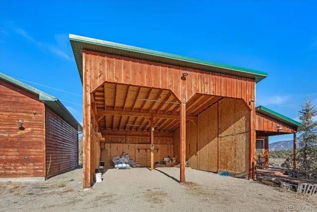 a backyard of a house with barbeque oven table and chairs